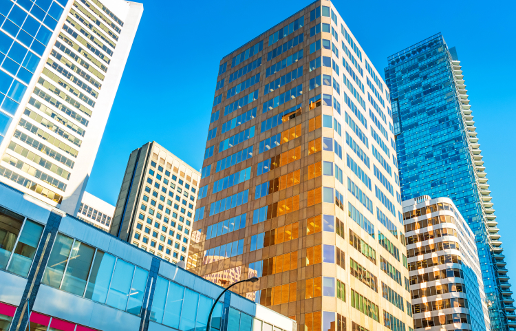 Colourful glass skyscrapers against a deep blue sky